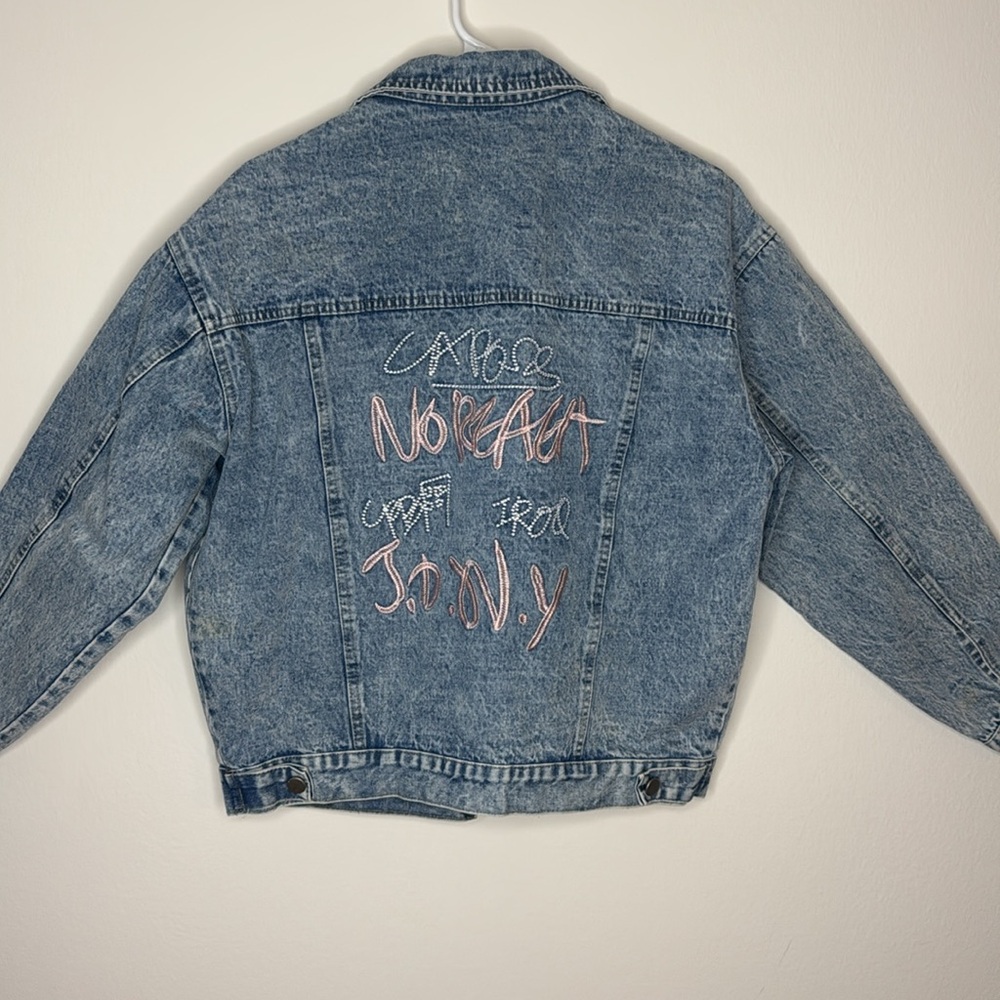 Size Medium. Distressed graphic denim jacket with embroidered pink graffiti